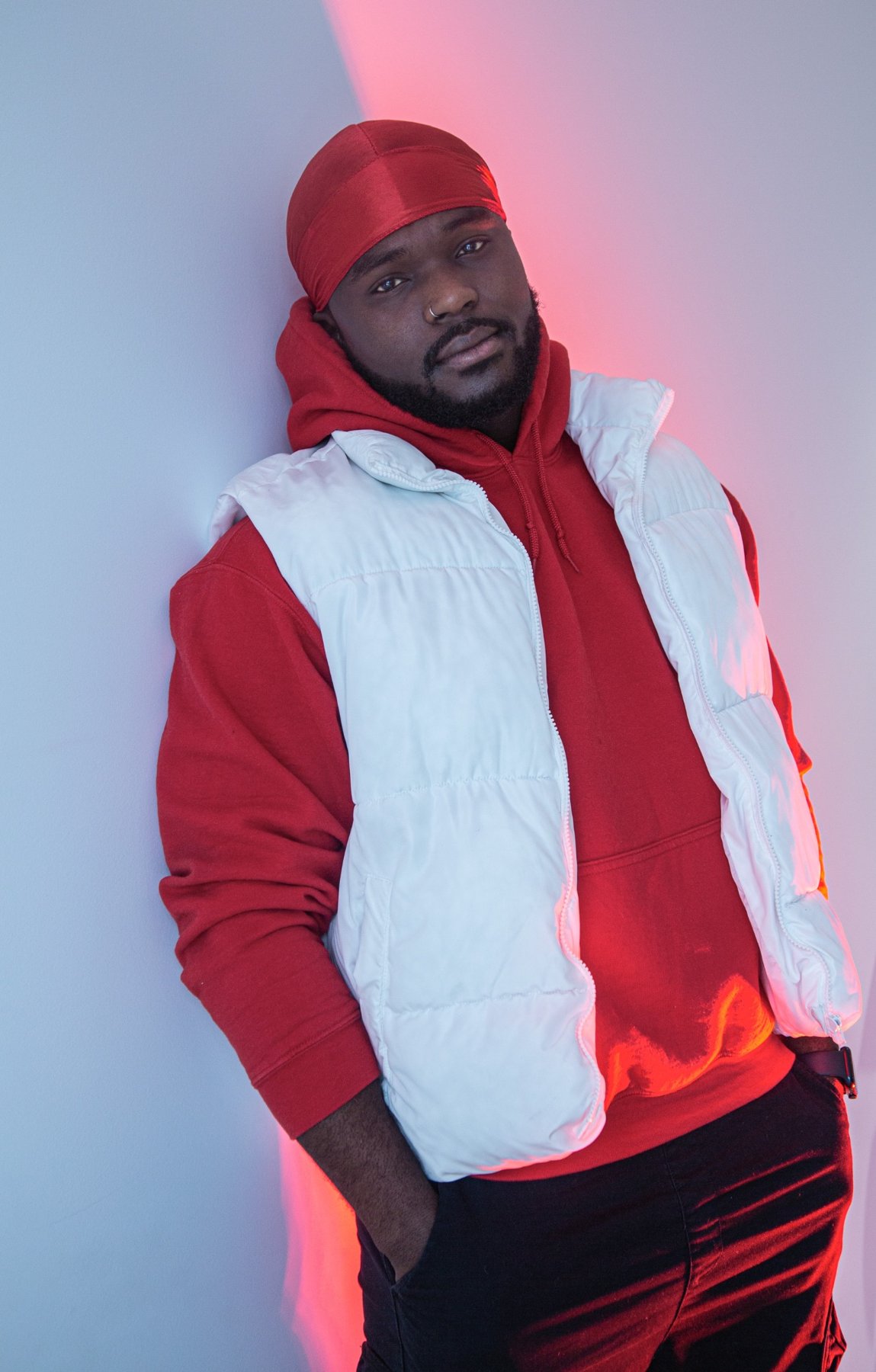 ELLI standing in red hoodie and white vest